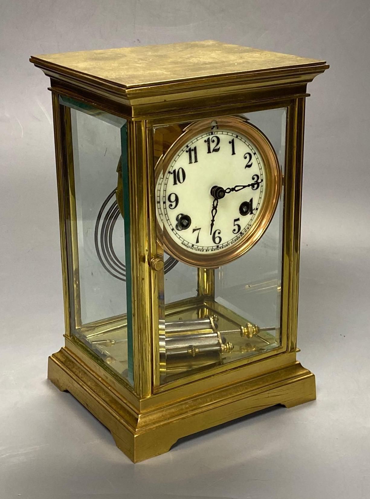 A lacquered brass four-glass mantel clock, Waterbury Clock Co., USA, gong striking movement, height 24cm